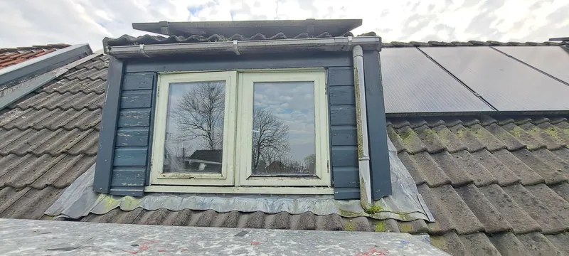 Dakkapel met crèmekleurige kozijnen en antracietgrijze zijwangen.